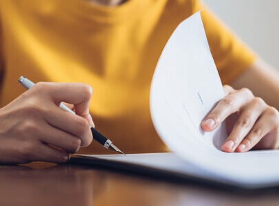 our-service Woman signing document and hand holding pen putting signature at paper, order to authorize their rights.
